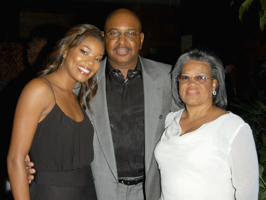 Gabrielle Union, her father Cully Union, and her stepmother Chris Union pose for a photo