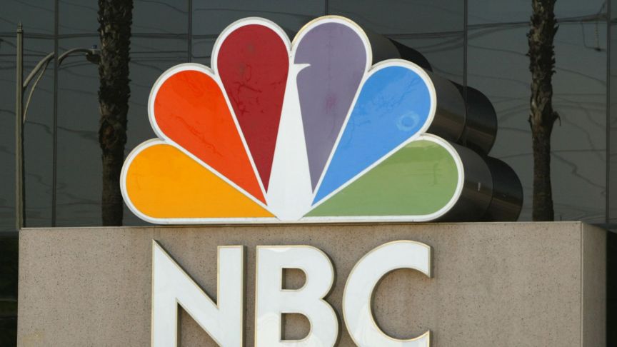 The NBC peacock logo is seen on the NBC studios building August 28, 2003 in Burbank, California. Paris-based Vivendi is in the final stages of a long and drawn-out auction of its U.S.-based media assets, collectively known as Vivendi Universal Entertainment, or VUE. NBC is an auction favorite