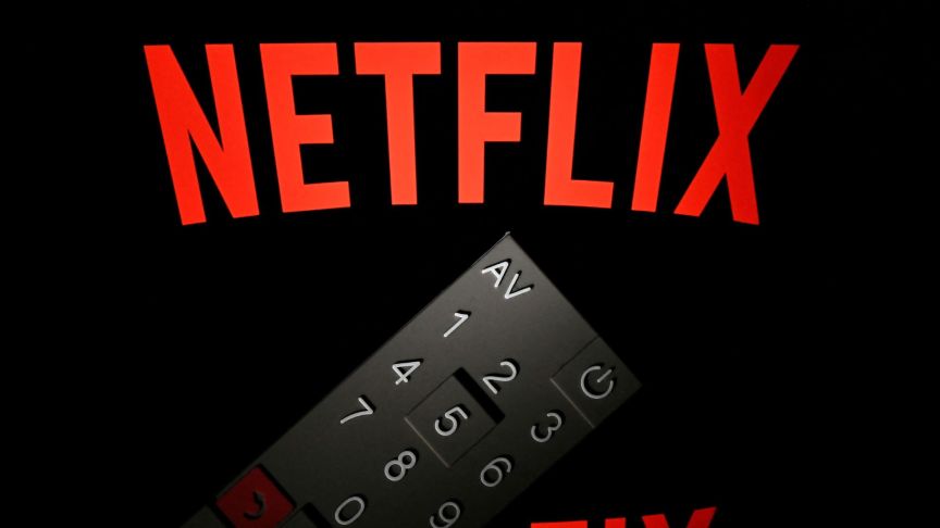 This illustration picture taken on April 21, 2018 in Paris shows the logo of the Netflix entertainment company, displayed on a tablet screen with a remote control in front of it.