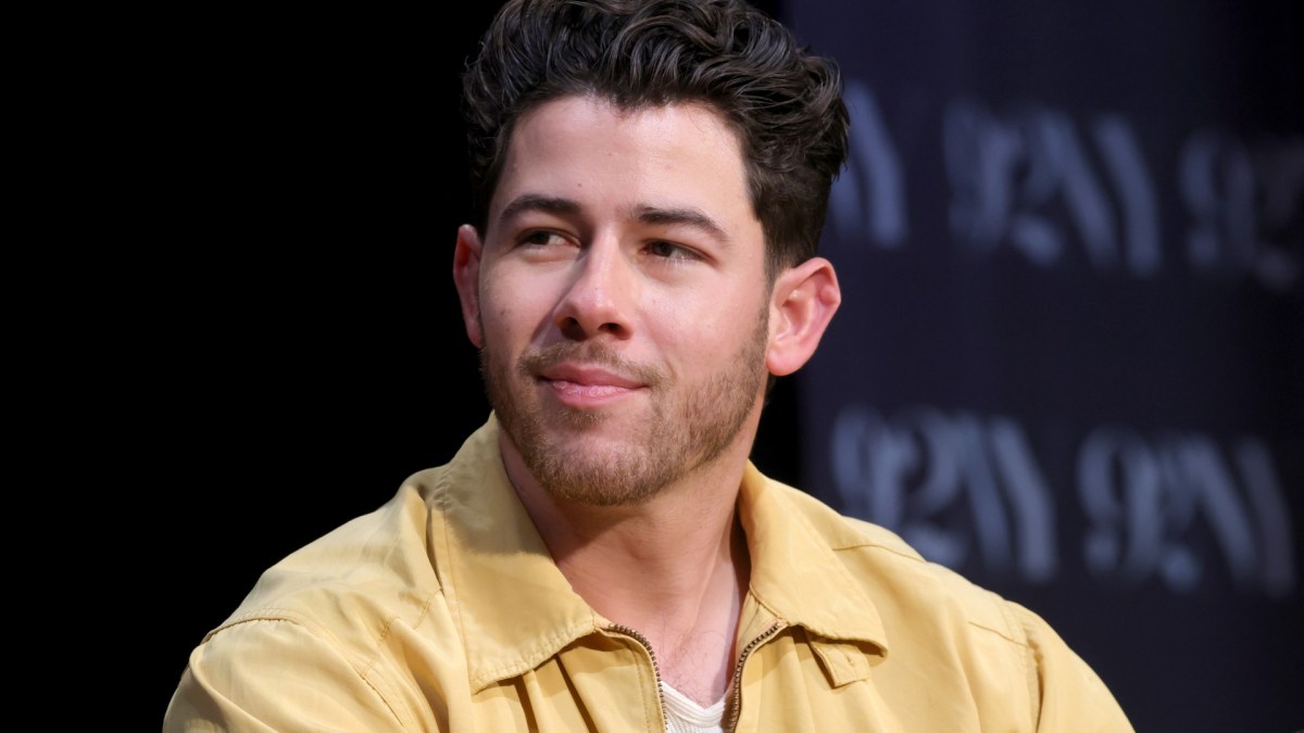 Nick Jonas wearing a yellow shirt