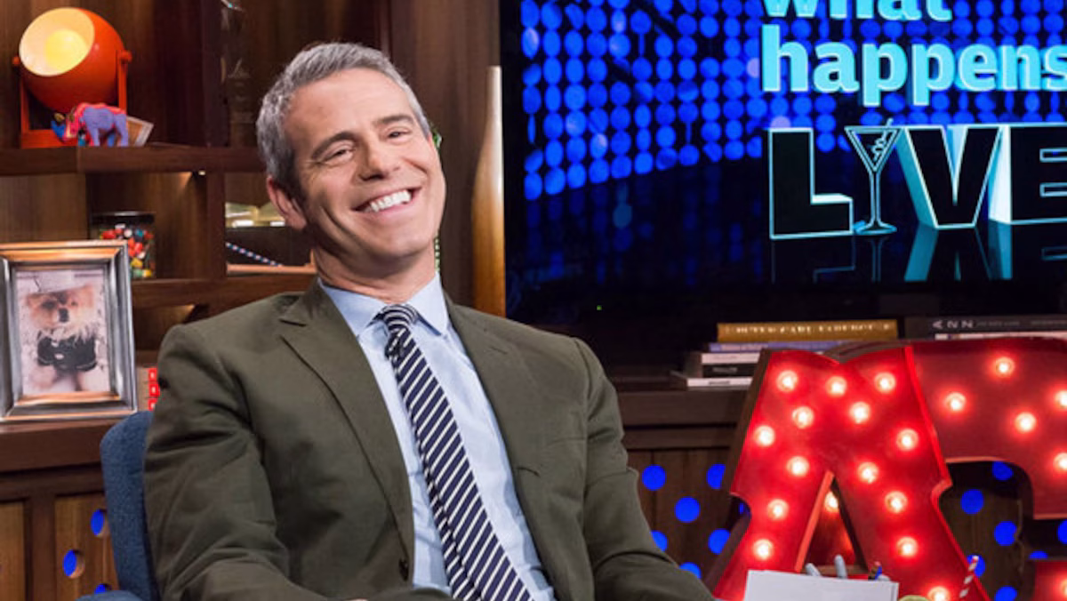 Andy Cohen smiles while seated on the set of "Watch What Happens Live"