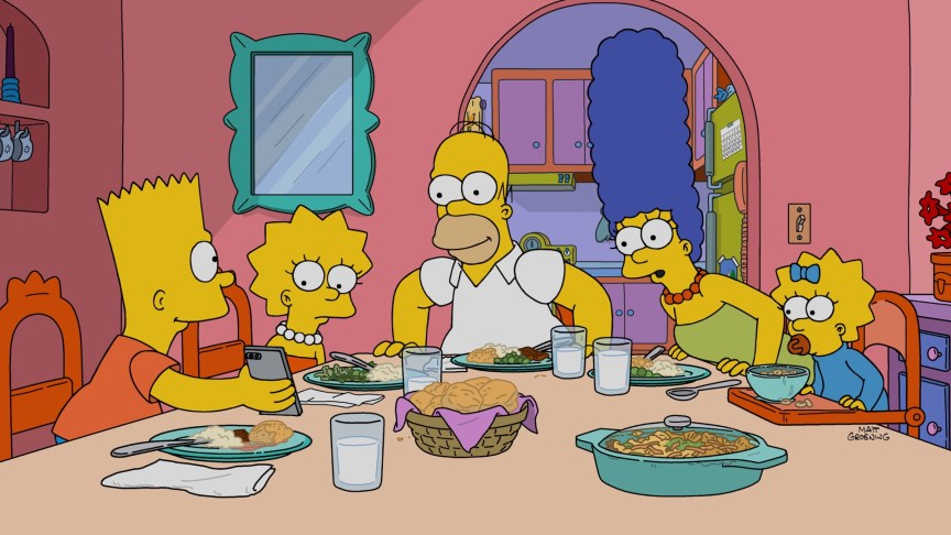 The Simpson family at the dinner table in a scene from 'The Simpsons'