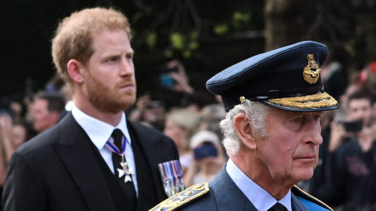 Britain's King Charles III and Britain's Prince Harry, Duke of Sussex walk behind the coffin of Queen Elizabeth II, adorned with a Royal Standard and the Imperial State Crown and pulled by a Gun Carriage of The King's Troop Royal Horse Artillery, during a procession from Buckingham Palace to the Palace of Westminster.