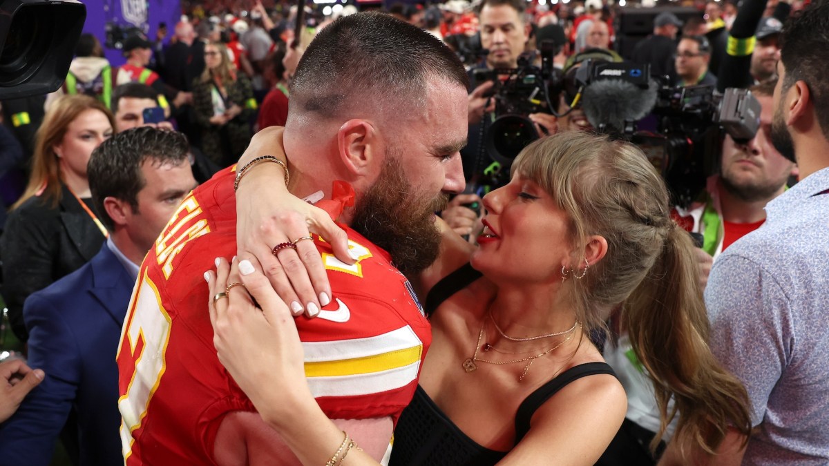 Travis Kelce and Taylor Swift about to kiss.
