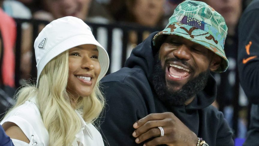 LeBron James and Savannah James attend an NBA game.