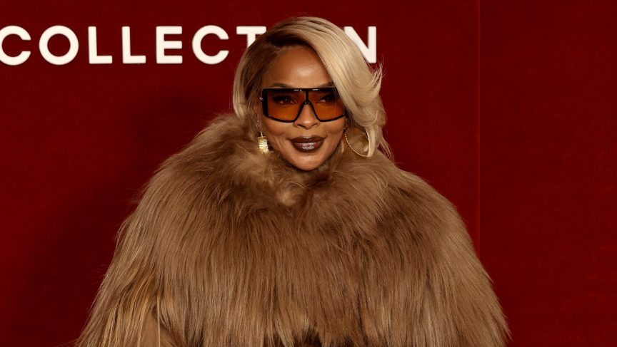Mary J. Blige smiling on the red carpet.