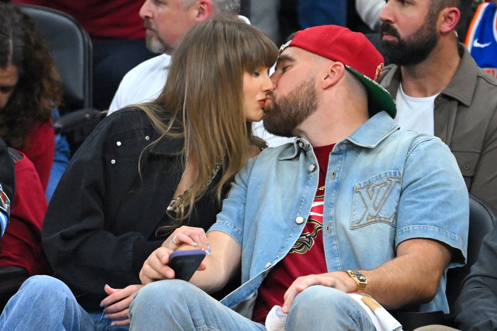 Singer Taylor Swift and Travis Kelce of the Kansas City Chiefs kiss during Game Three between the New York Knicks and the Cleveland Cavaliers in the NBA Eastern Conference Finals at Rocket Arena on May 23, 2026 in Cleveland, Ohio. Photo by Jason Miller/Getty Images. 