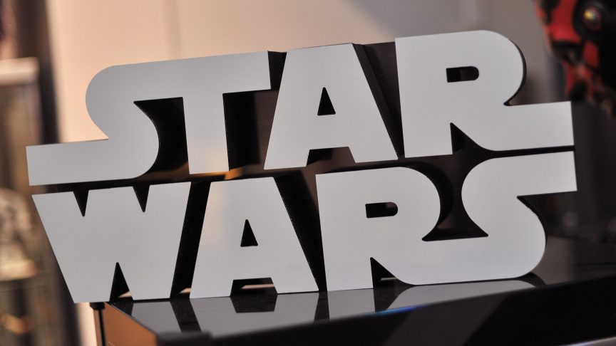 A Star Wars logo sign is seen atop a popcorn machine.