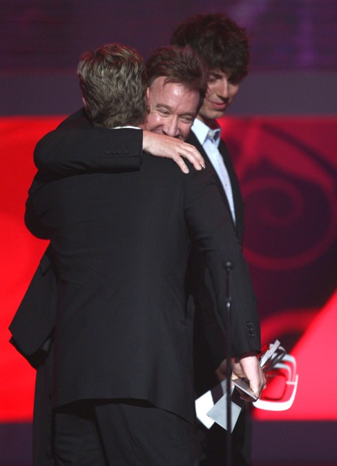 Tim Allen onstage accepting an award for "Home Improvement"