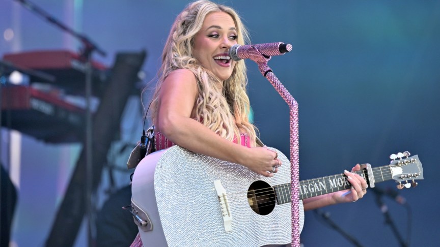 Megan Moroney playing guitar onstage