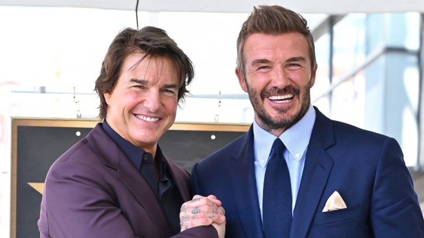 Tom Cruise and David Beckham smile and clap hands.