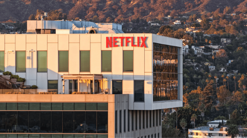 LOS ANGELES, CALIFORNIA - DECEMBER 05: An aerial view of the Netflix logo displayed at Netflix studios, with the Hollywood sign in the distance, on December 5, 2025 in Los Angeles, California. Netflix and Warner Bros. Discovery, Inc. have announced an $82.7 billion deal for Netflix to acquire Warner Bros. film and TV studios, HBO Max, and HBO. (Photo by Mario Tama/Getty Images)