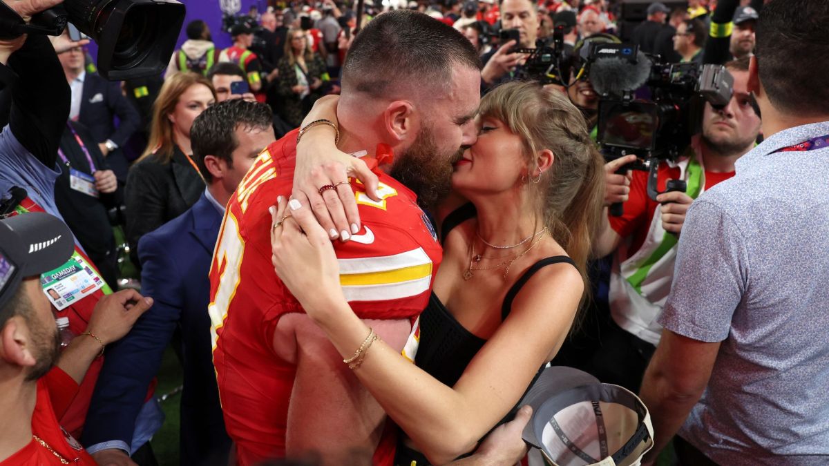 Travis Kelce #87 of the Kansas City Chiefs kisses Taylor Swift after defeating the San Francisco 49ers 25-22 in overtime during Super Bowl LVIII at Allegiant Stadium.