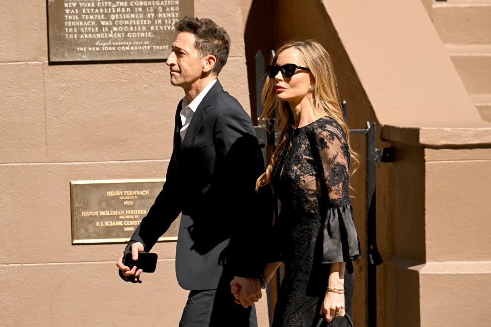 Adrien Brody and Georgina Chapman holding hands