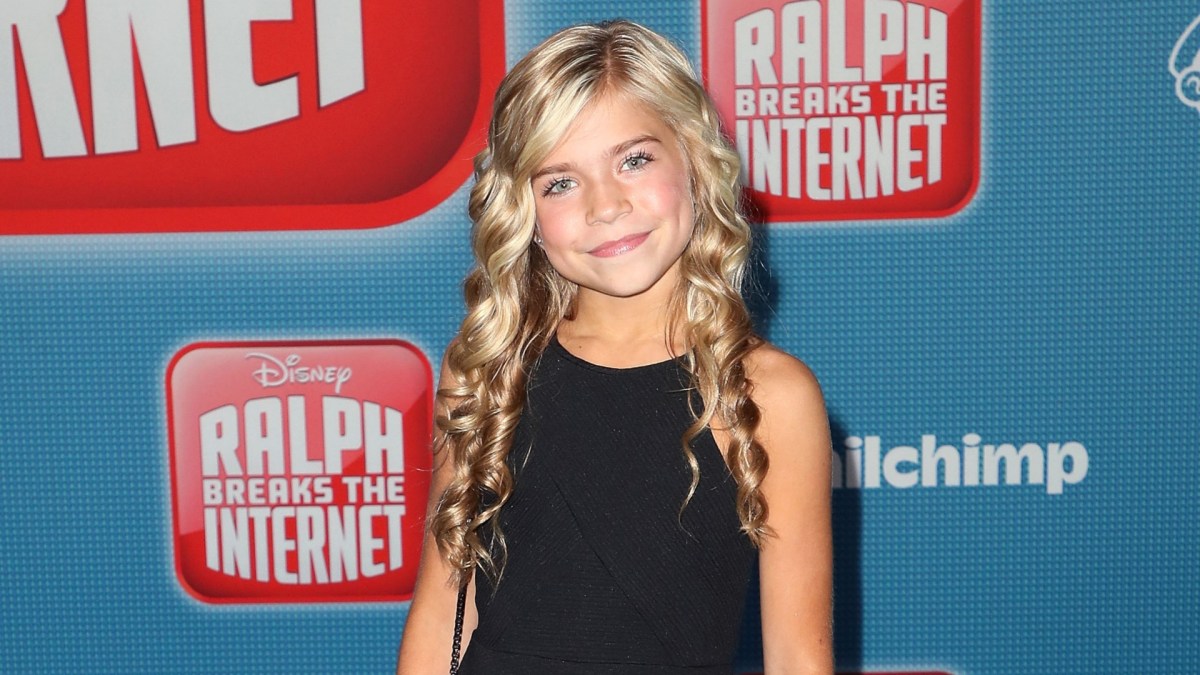 Kamri Peterson at 10 smiles in a black dress.